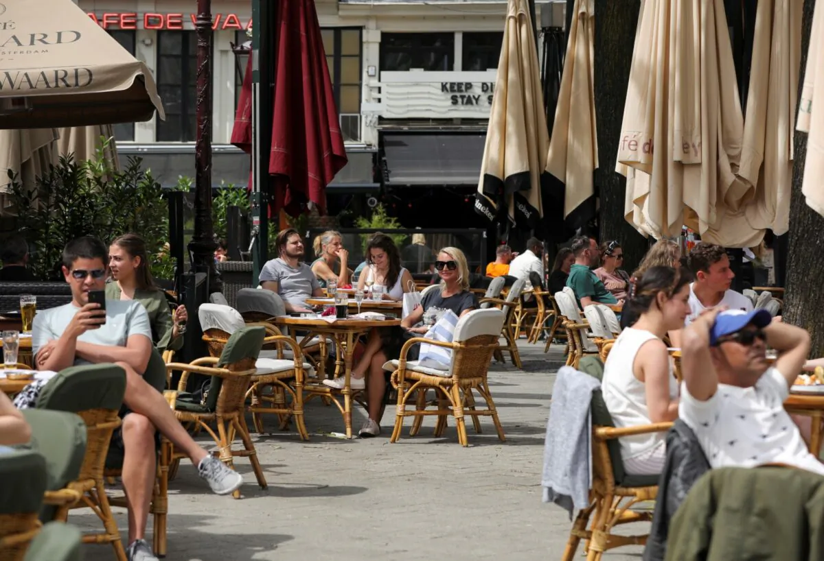Customers enjoy their drinks at the newly reopened cafes on Leidseplein Square, as Netherlands eases some of the lockdown measures put in place during the (COVID-19) outbreak, in Amsterdam, Netherlands, on June 1, 2020. (Eva Plevier/File Photo/Reuters)