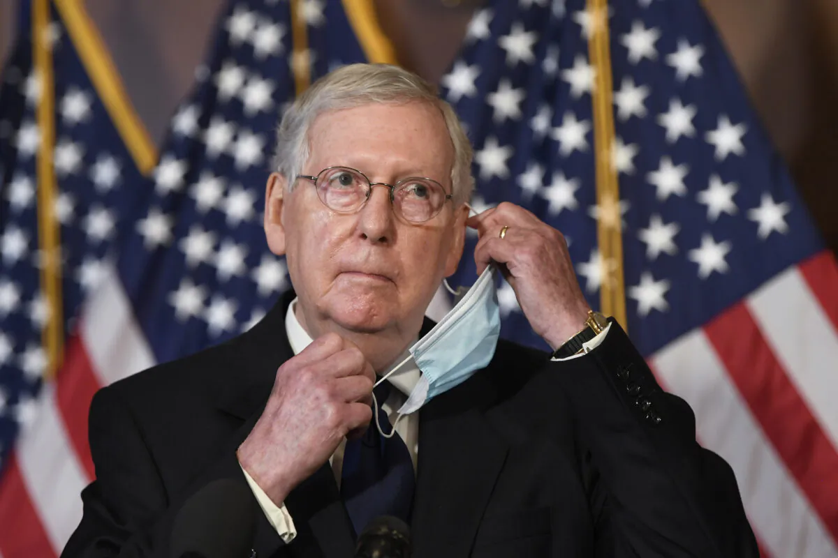 Senate Majority Leader Mitch McConnell (R-Ky.) adjusts his mask during a news conference on Capitol Hill in Washington on, July 27, 2020. (Susan Walsh/AP Photo)