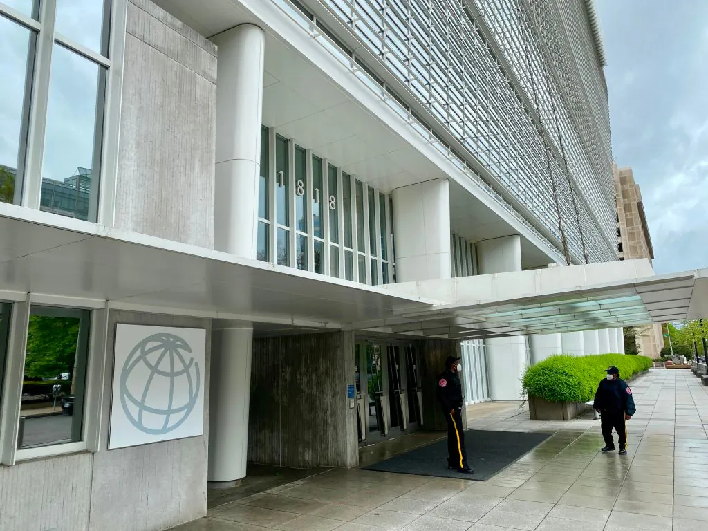 A security guard walks near the World Bank Group building  on an empty street in Washington, on April 13, 2020. DANIEL SLIM/AFP via Getty Images