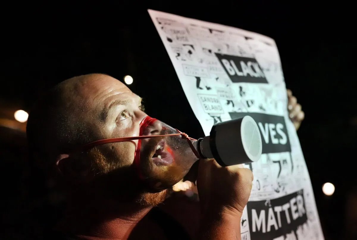 A protester with a home-made gas mask chants toward the Mark O. Hatfield Courthouse in Portland, Ore., on July 30, 2020. (Nathan Howard/Getty Images)