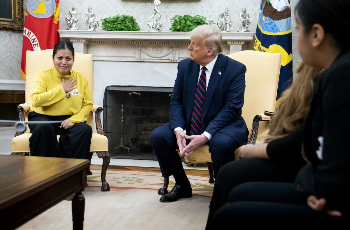 President Donald Trump looks on as the mother of murdered Fort Hood soldier Vanessa Guillen, Gloria Guillen talks about her daughter murder during a meeting with the family in the Oval Office, on July 30, 2020. (Doug Mills/The New York Times via Getty Images)