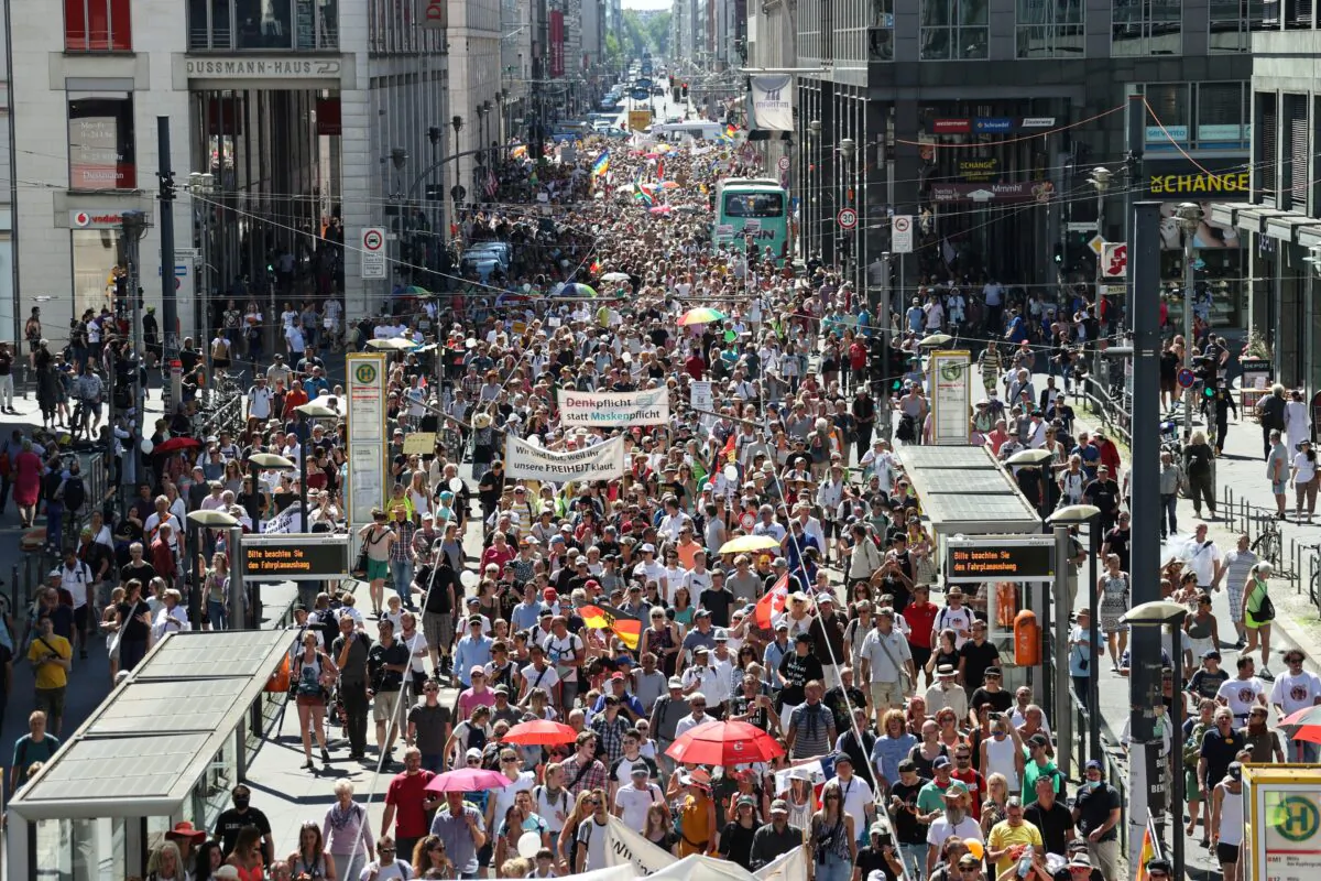 Demonstrators march during a protest against the government's restrictions amid the CCP virus outbreak, in Berlin on Aug. 1, 2020. (Fabrizio Bensch/Reuters)
