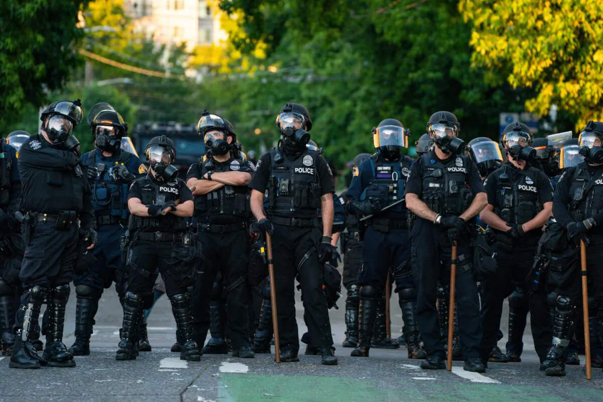 Police block a road during protests near the Seattle Police East Precinct in Seattle, Wash., on July 26, 2020. (David Ryder/Getty Images)