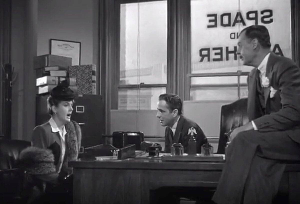 women in private detective office with two men