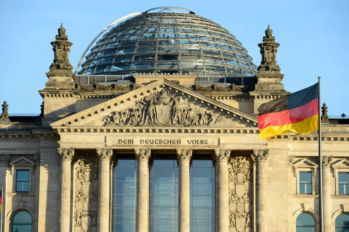 The German national flag is seen in front of the Reichstag building housing the German parliament Bundestag on Dec. 16, 2013. (John Macdougall/AFP via Getty Images)