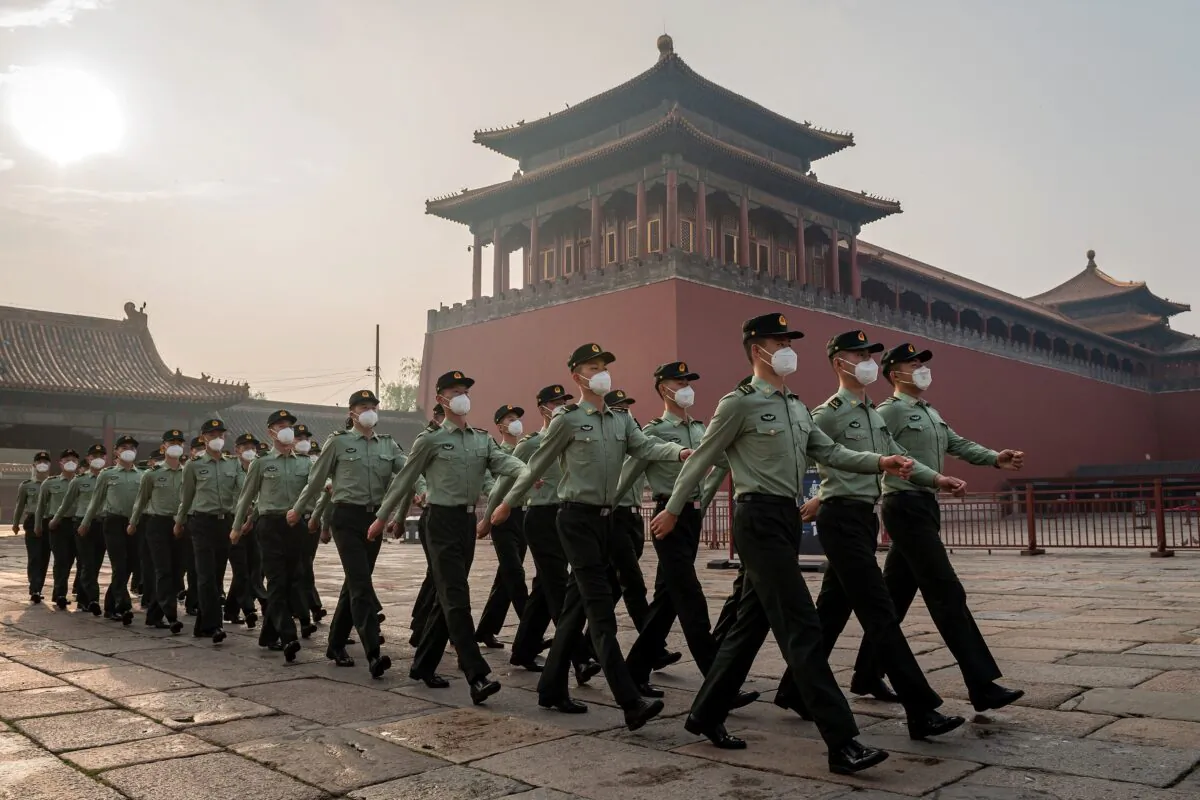 People's Liberation Army soldiers march next to the entrance to the Forbidden City on May 21, 2020, the day before the beginning of the two-week National People's Congress. (Nicolas Asfouri/AFP via Getty Images)