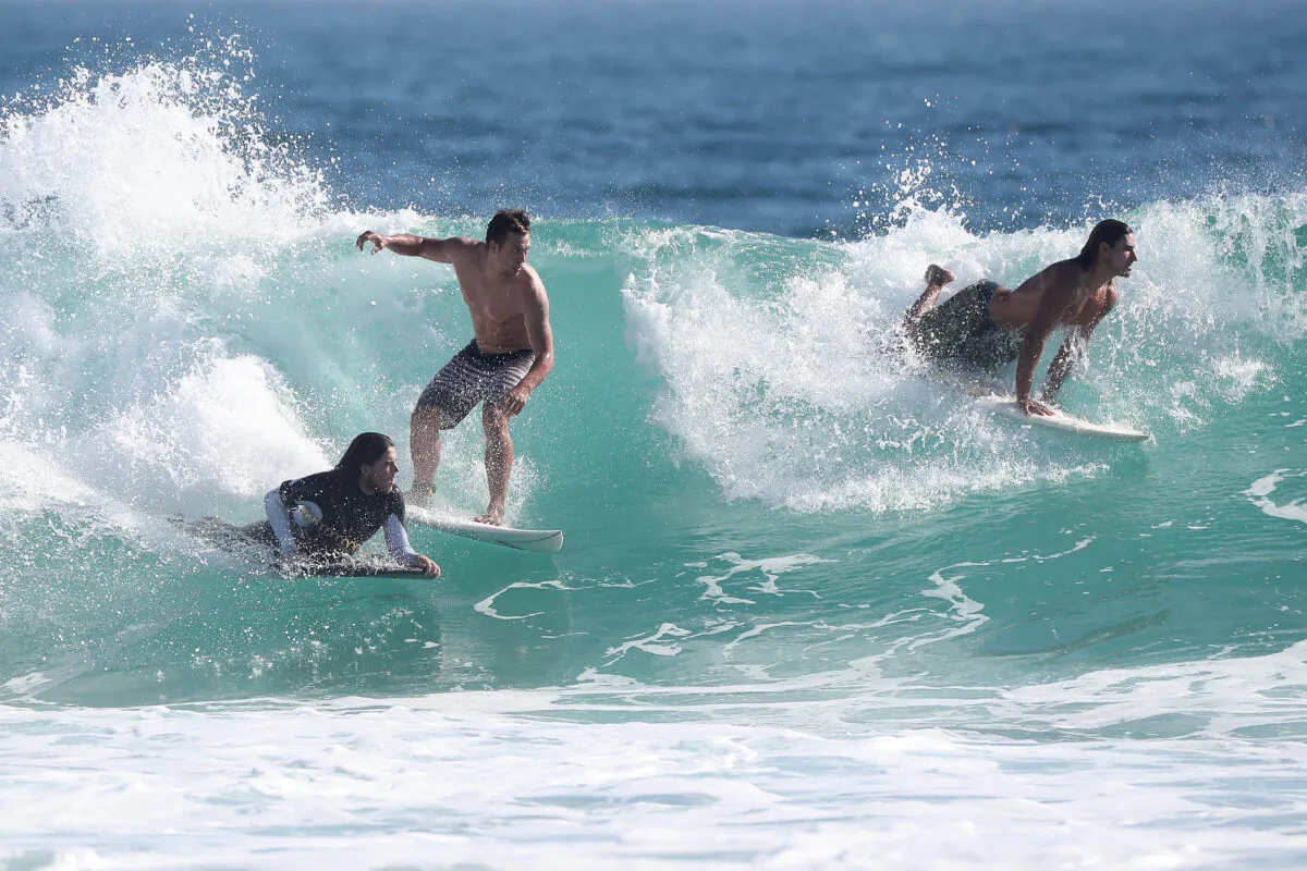 Surfers catch some waves at Trigg Beach, Perth, Australia on April 10, 2020. (Paul Kane/Getty Images)