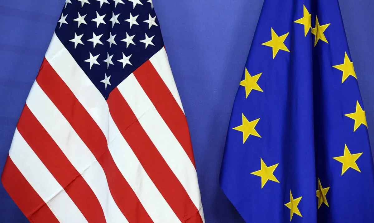 The U.S. national flag (L) and the European Union flag are seen side-by-side during a meeting at the EU Commission headquarter in Brussels on July 13, 2015. (Thierry Charlier/AFP via Getty Images)