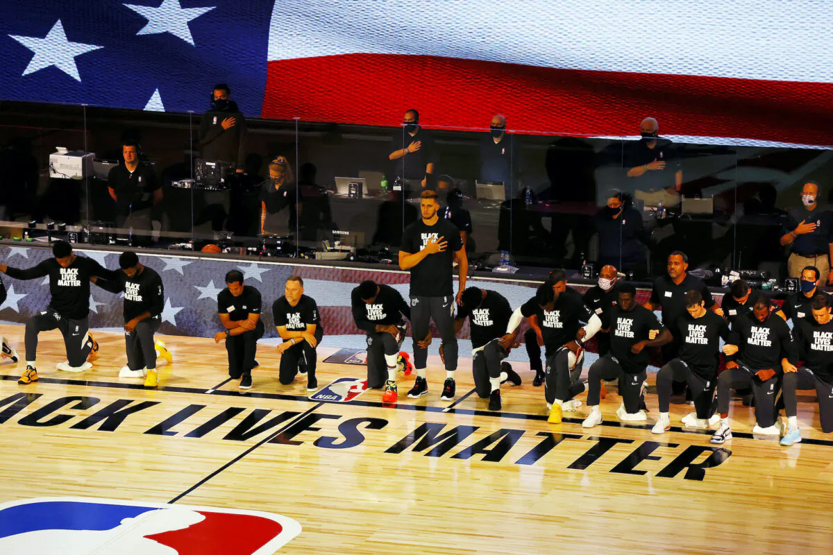 Miami Heat's Meyers Leonard stands during the national anthem before an NBA basketball game against the Denver Nuggets, Saturday, Aug. 1, 2020, in Lake Buena Vista, Fla. (Kevin C. Cox/Pool Photo via AP)
