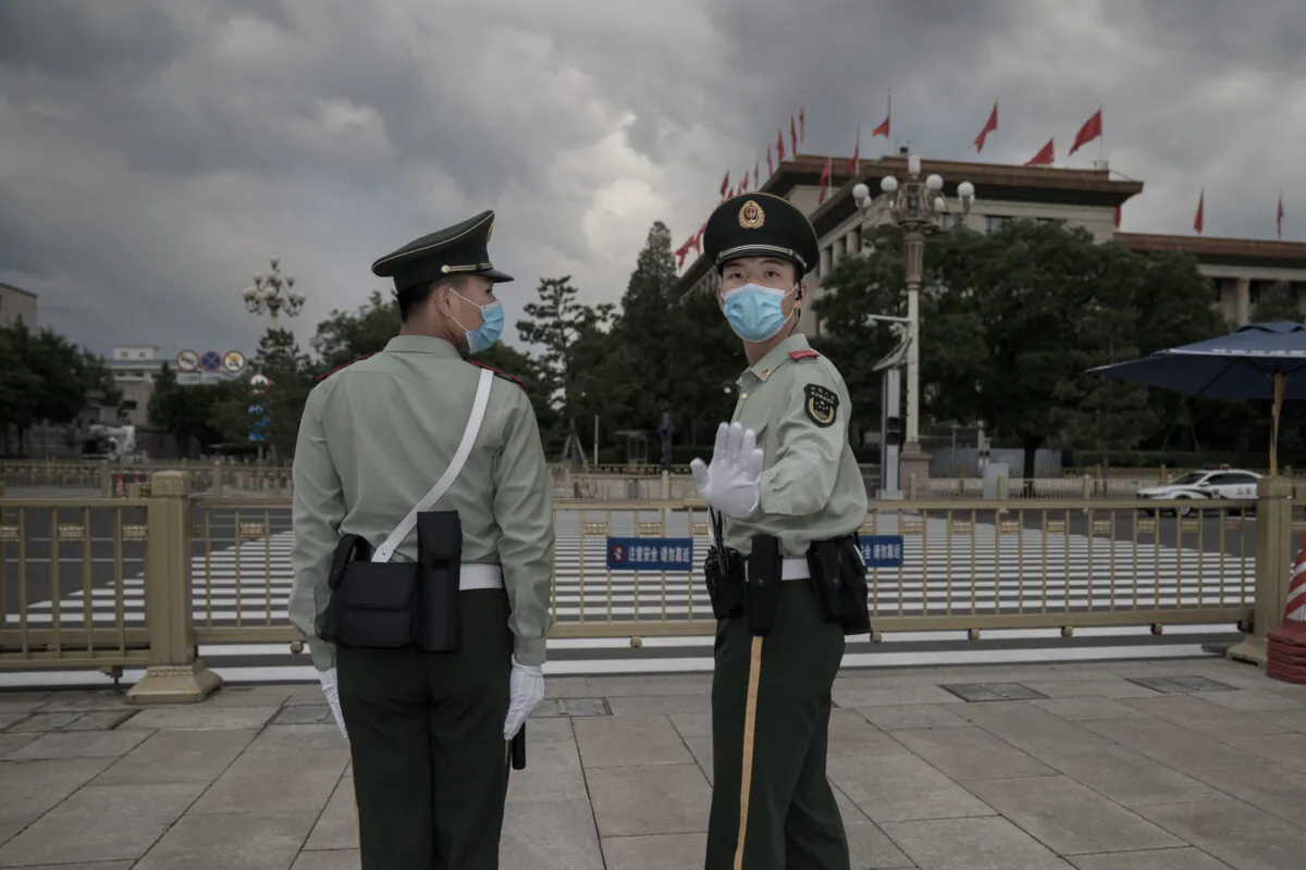 A People's Liberation Army soldier stops a photojournalist from shooting in Tiananmen Square at The Great Hall of People in Beijing on May 25, 2020. (Andrea Verdelli/Getty Images)