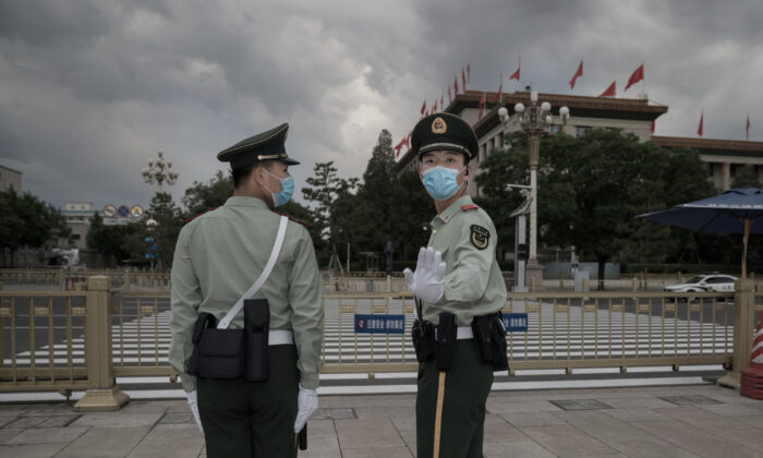 Soldiers of the People's Liberation Army stand guard outside The Great Hall of People in Tiananmen Square in Beijing on May 25, 2020. (Andrea Verdelli/Getty Images)