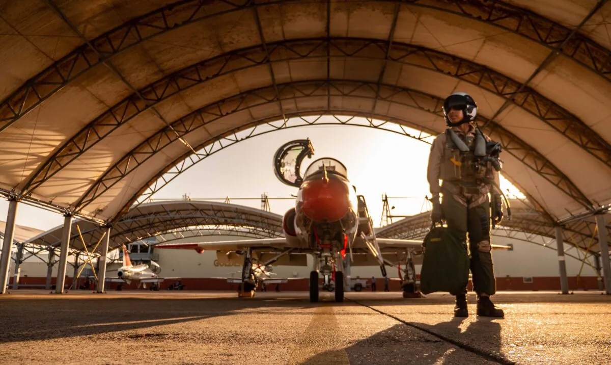 Lt. j.g. Madeline "Maddy" Swegle poses for a photograph in front of a U.S. Navy T-45 Goshawk training aircraft during undergraduate Tactical Air (Strike) pilot training syllabus at Naval Air Station Kingsville, Texas, on July 29, 2020. Swegle is the Navy's first black female to graduate and become a tactical jet aviator. (Austin Rooney/U.S. Navy)