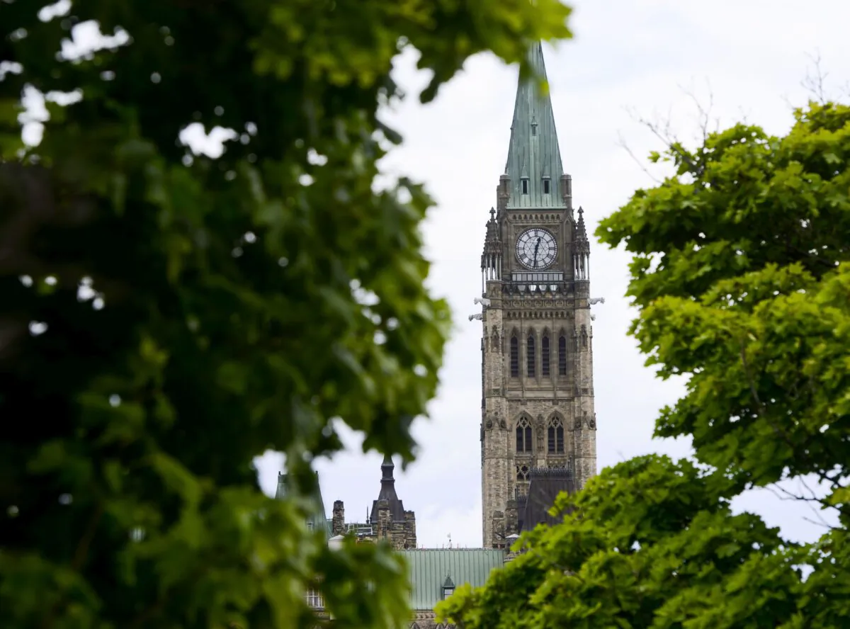 The Peace Tower is seen through the trees on Parliament Hill on July 20, 2020. Recipients of the Canada Emergency Response Benefit will be transferred to a revamped employment insurance system. (The Canadian Press/Sean Kilpatrick)