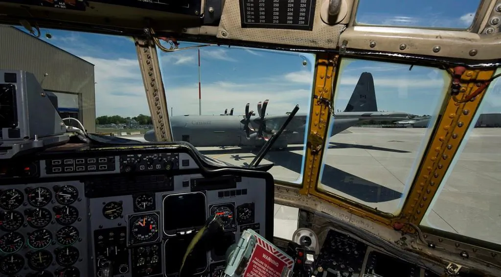 The first of 17 new CC-130J Hercules aircraft is seen through the cockpit of an older model of the Hercules after landing at Canadian Forces Base (CFB) Trenton on June 4, 2010. (The Canadian Press/Adrien Veczan)
