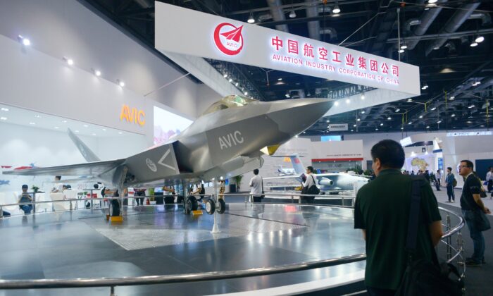 A man looks at a J-31 gyrfalcon stealth fighter plane model designed by Aviation Industry Corporation of China (AVIC) at the Beijing International Aviation Expo in Beijing on Sept. 17, 2015. (WANG ZHAO/AFP via Getty Images)