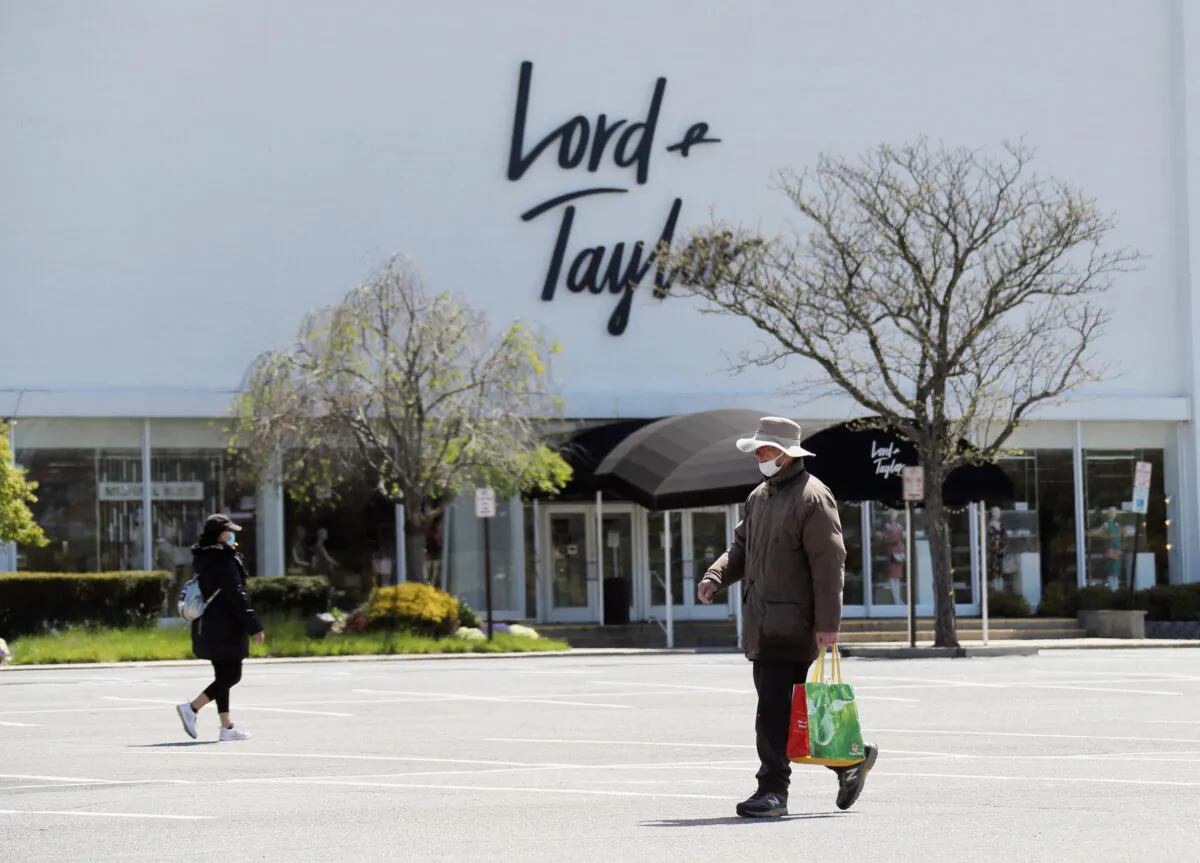 Pedestrians walk past a shuttered Lord and Taylor department store following their filing for bankruptcy amid the COVID-19 pandemic in Garden City, N.Y., on May 12, 2020. (Bruce Bennett/Getty Images)