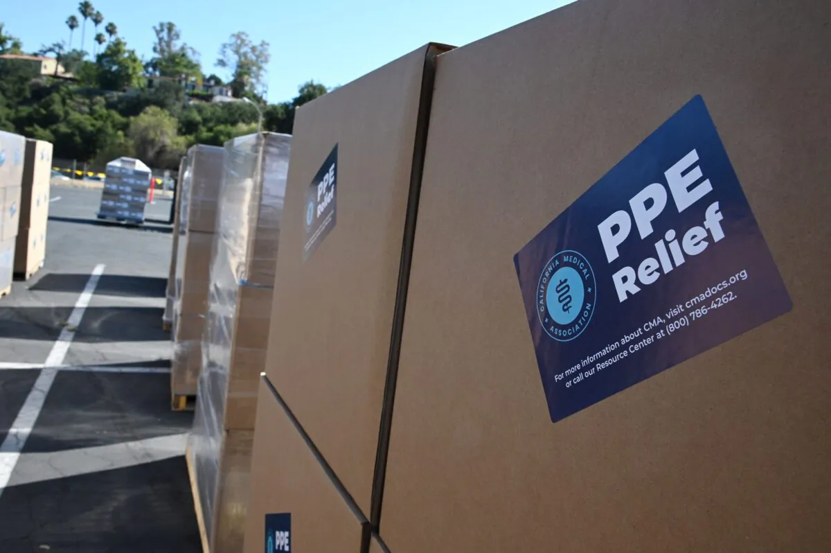 Boxes full of medical-grade personal protective equipment (PPE) are prepared for dispersal at a drive-through distribution centre set up in a Rose Bowl parking lot in Pasadena, Calif., on July 27, 2020. (Robyn Beck/ AFP via Getty Images)