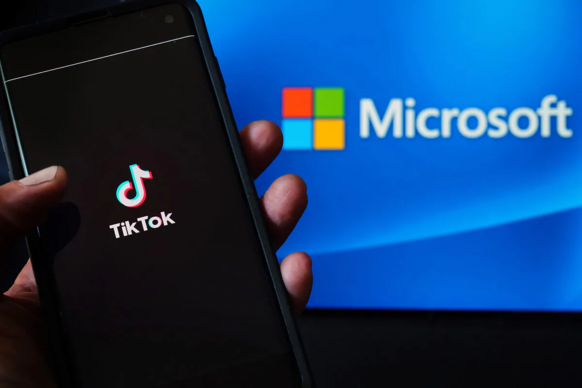 In this photo illustration, a mobile phone featuring the TikTok app is displayed next to the Microsoft logo in New York City on Aug. 3, 2020. (Cindy Ord/Getty Images)