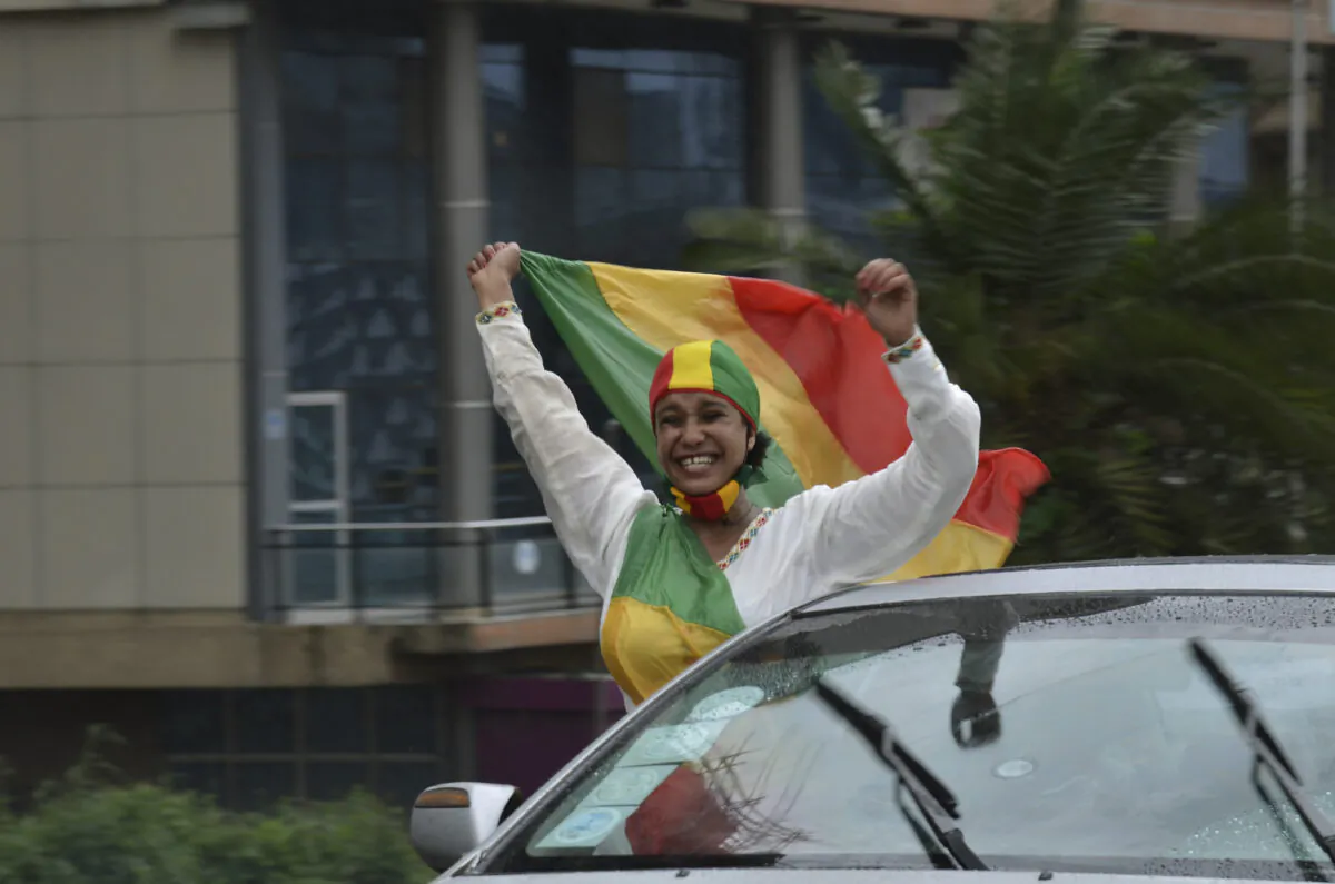A woman reacts to the progress made on the Nile dam, during celebrations, in Addis Ababa, Ethiopia, on Aug. 2, 2020.   (AP Photo/Samuel Habtab)