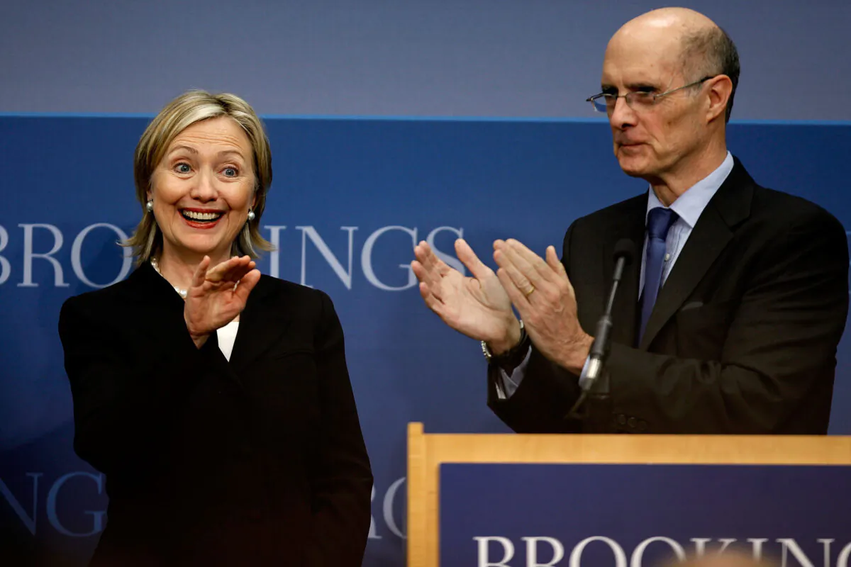 Secretary of State Hillary Clinton (L) is applauded by Brookings Institution President Strobe Talbott before she delivers remarks about the Obama administration's national security strategy at the Brookings Institution May 27, 2010, in Washington. (Chip Somodevilla/Getty Images)