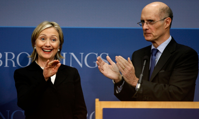 Secretary of State Hillary Clinton (L) is applauded by Brookings Institution President Strobe Talbott before she delivers remarks about the Obama administration's national security strategy at the Brookings Institution May 27, 2010, in Washington. (Chip Somodevilla/Getty Images)