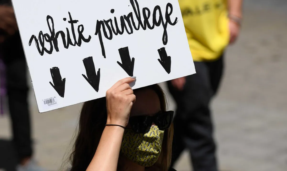 A woman holds a placard reading "white privilege" during a demonstration in Barcelona, Spain, on June 14, 2020. (Josep Lago/AFP via Getty Images)