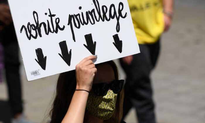 A woman holds a placard reading "white privilege" during a demonstration in Barcelona, Spain, on June 14, 2020. (Josep Lago/AFP via Getty Images)