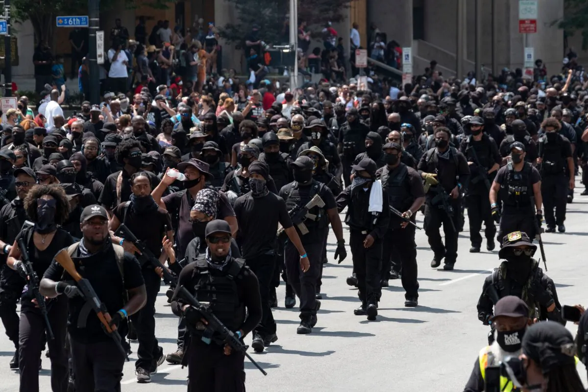 Members of the "Not [Expletive} Around Coalition" (NFAC), an all-black militia, march during a rally to protest the killing of Breonna Taylor, in Louisville, Ky., on July 25, 2020. (Photo by Jeff Dean/AFP via Getty Images)