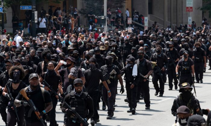 Members of the "Not [Expletive} Around Coalition" (NFAC), an all-black militia, march during a rally to protest the killing of Breonna Taylor, in Louisville, Ky., on July 25, 2020.  (Photo by Jeff Dean/AFP via Getty Images)