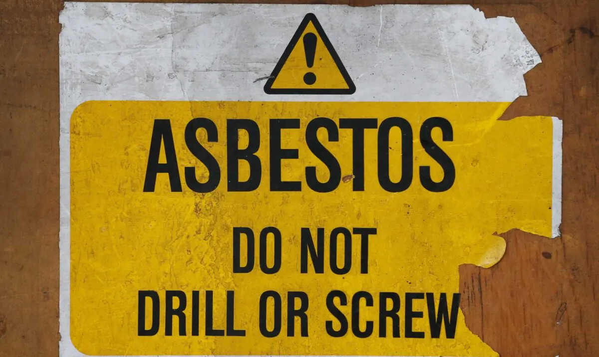 A sign warns of asbestos danger at a former Royal Mail sorting office in London, England, on Oct. 11, 2013. (Peter Macdiarmid/Getty Images)