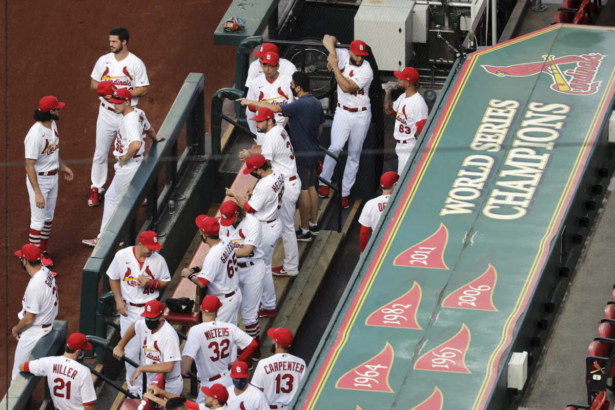 Members of the St. Louis Cardinals wait to be introduced before the start of a baseball game against the Pittsburgh Pirates in St. Louis, Detroit, Michigan, on July 24, 2020. (AP Photo/Jeff Roberson)