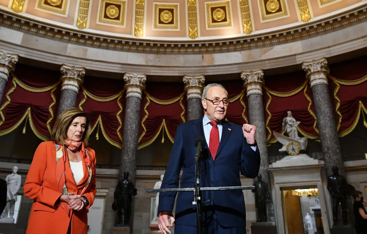 Senate Minority Leader Sen. Chuck Schumer (D-N.Y.) speaks to reporters as House Speaker Nancy Pelosi (D-Calif.) listens, at the U.S. Capitol on Aug. 4, 2020. (Mandel Ngan/AFP via Getty Images)
