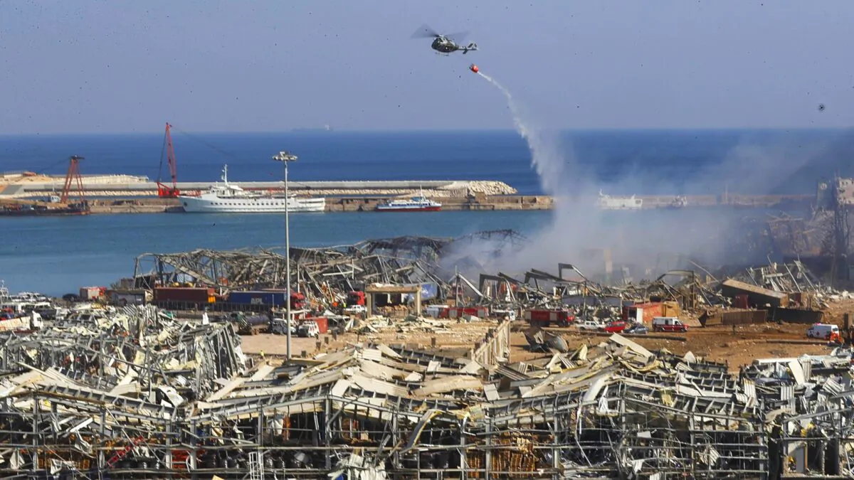A Lebanese army helicopter throw water at the scene where an explosion hit the seaport of Beirut, Lebanon on Aug. 5, 2020. (Hussein Malla/AP Photo)