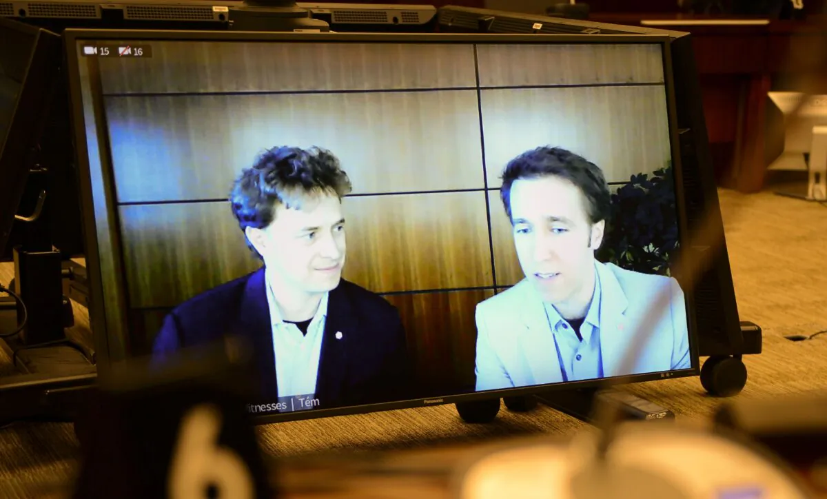 Marc Kielburger (L) and his brother Craig appear as witnesses via videoconference during a House of Commons finance committee hearing on the WE Charity scandal in the Wellington Building in Ottawa on July 28, 2020. (The Canadian Press/Sean Kilpatrick)