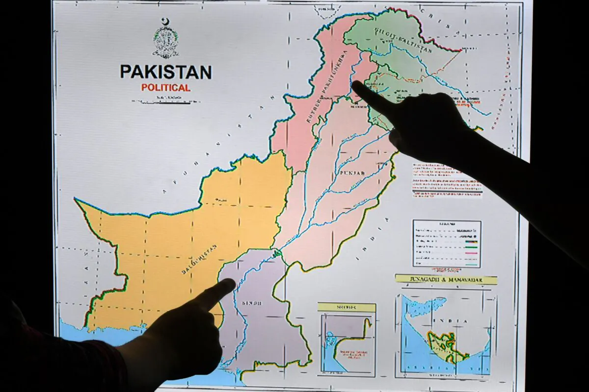 Journalists look at Pakistan's new political map on a screen at the Daily Metro Watch newspaper offices in Islamabad on Aug. 4, 2020. (AAMIR QURESHI/AFP via Getty Images)