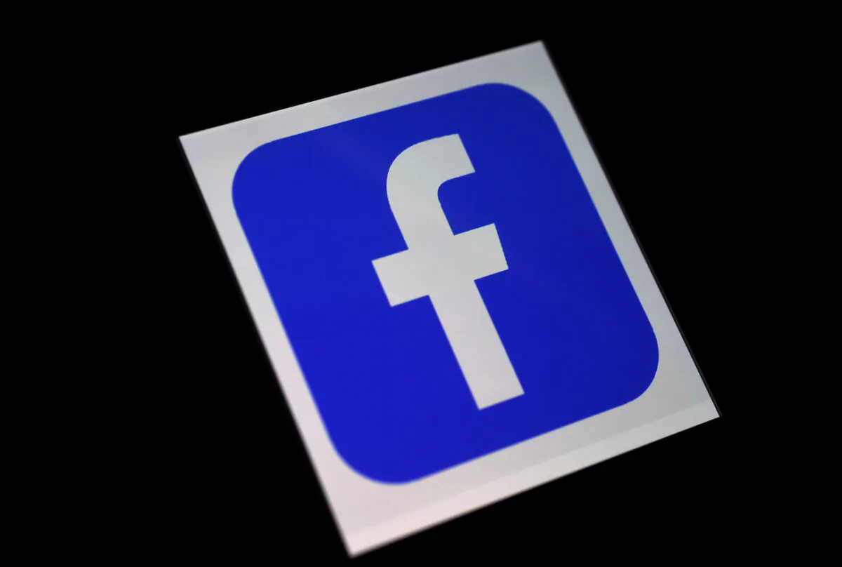 A Facebook App logo is displayed on a smartphone. (Olivier Douliery/AFP via Getty Images)