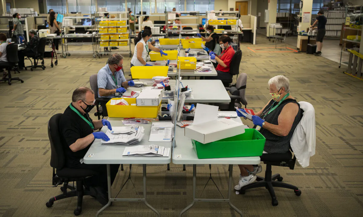 Mail-in ballots are processed for Washington's primary election by elections workers at the King County Elections headquarters in Renton, Washington, on August 4, 2020. (David Ryder/Getty Images)