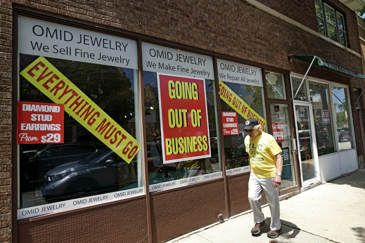 A man walks past a retail store that is going out of business due to the coronavirus pandemic in Winnetka, Ill., on June 23, 2020. (Nam Y. Huh/AP Photo)