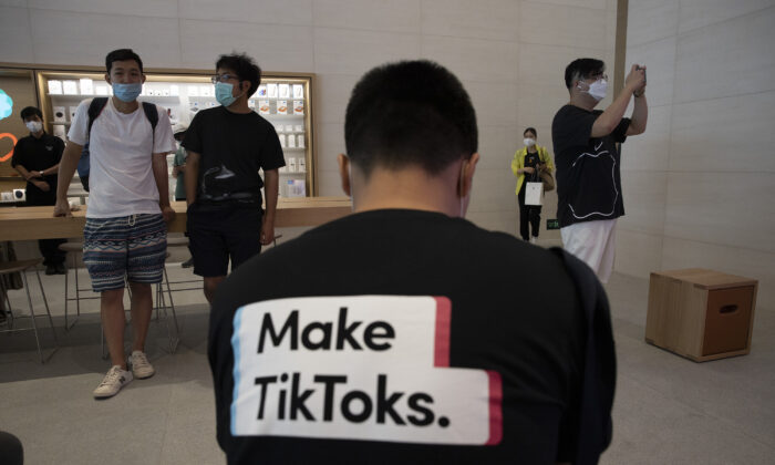 A man wearing a shirt promoting TikTok is seen at an Apple store in Beijing on July 17, 2020. (Ng Han Guan/AP Photo)