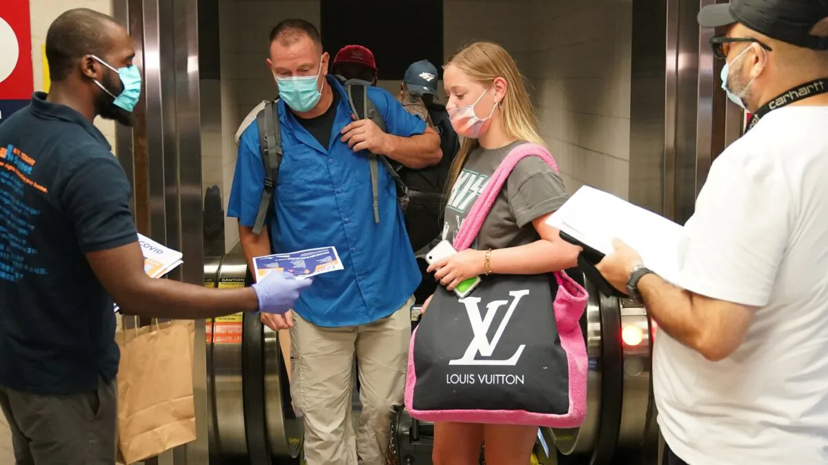Passengers on a train from Florida stop and register with officials during an effort to screen out-of-state travelers at Penn Station in New York City, on August 6, 2020. (Carlo Allegri/Reuters)