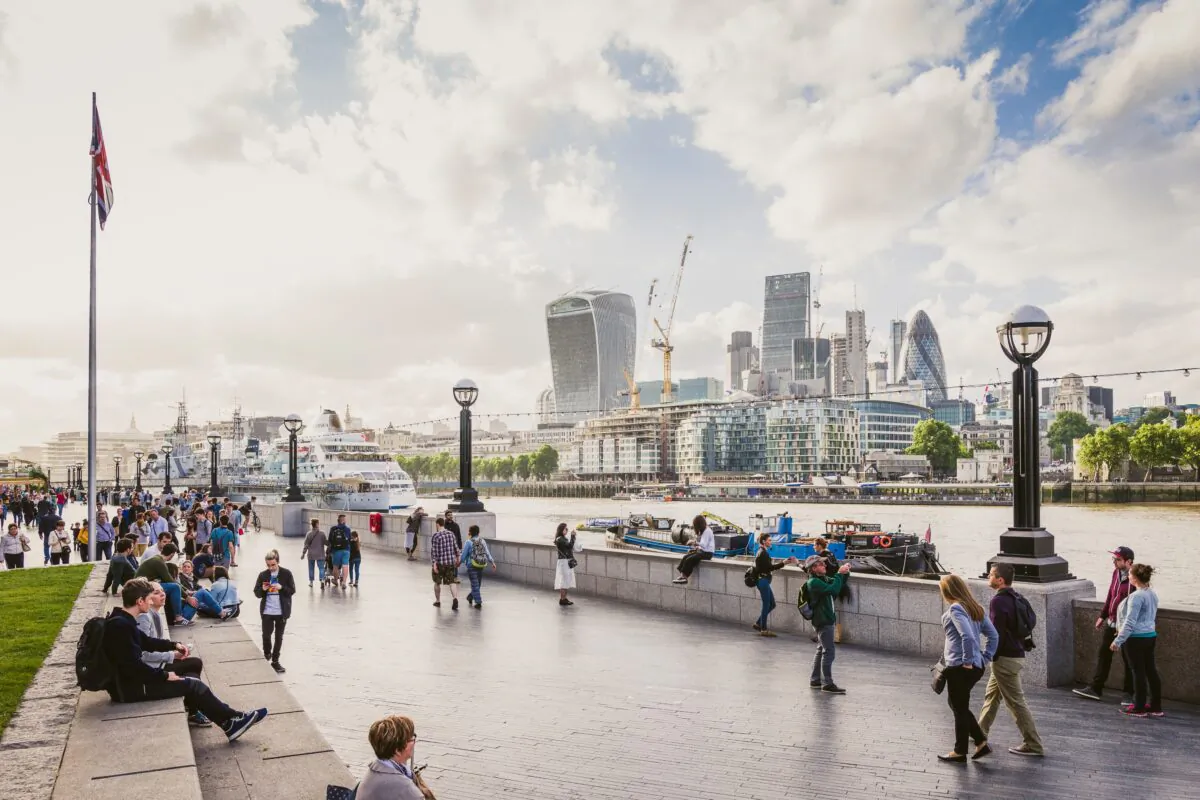 Couples and tourists stroll along the South Bank in London, England, in this file photo. Received Pronunciation, or the 'Queen's English,' has been ranked the most attractive accent in a survey of British people by dating website eHarmony. (Mike Stezycki/Unsplash)