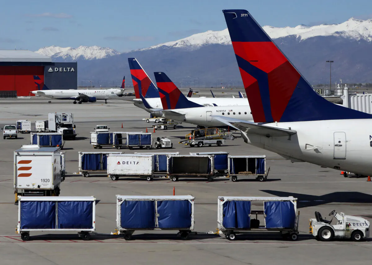 Delta Airlines planes are loaded and unloaded at Salt Lake City International Airport in Salt Lake City, Utah, on April 14, 2020. (Jim Urquhart/Reuters)