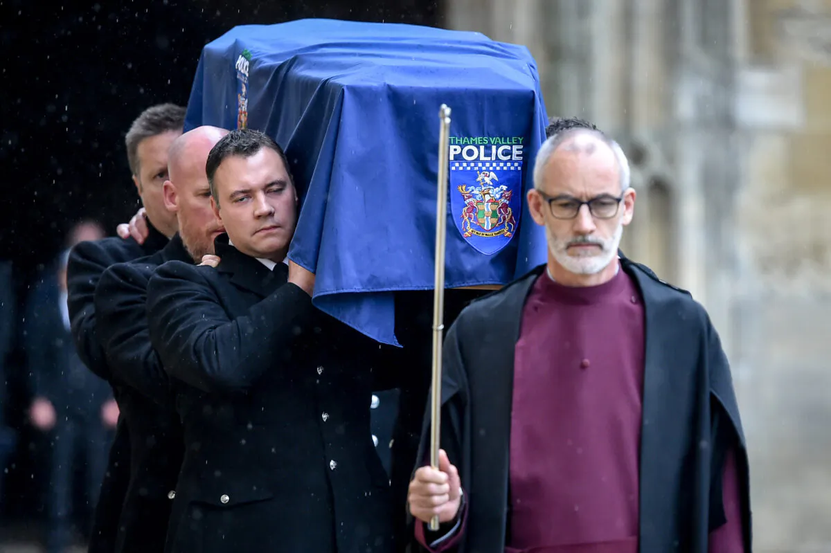 Clergy lead the pallbearers as they carry the coffin of PC Andrew Harper during his funeral at Christ Church Cathedral in Oxford, England, on Oct. 14, 2019. (Ben Birchall - Pool/Getty Images)