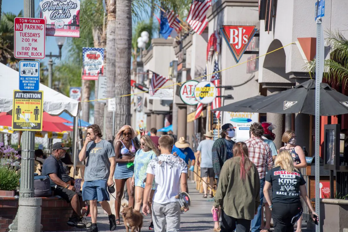 People browse restaurants and shops in downtown Huntington Beach, Calif., on July 16, 2020. (Robin Beck/AFP via Getty Images)