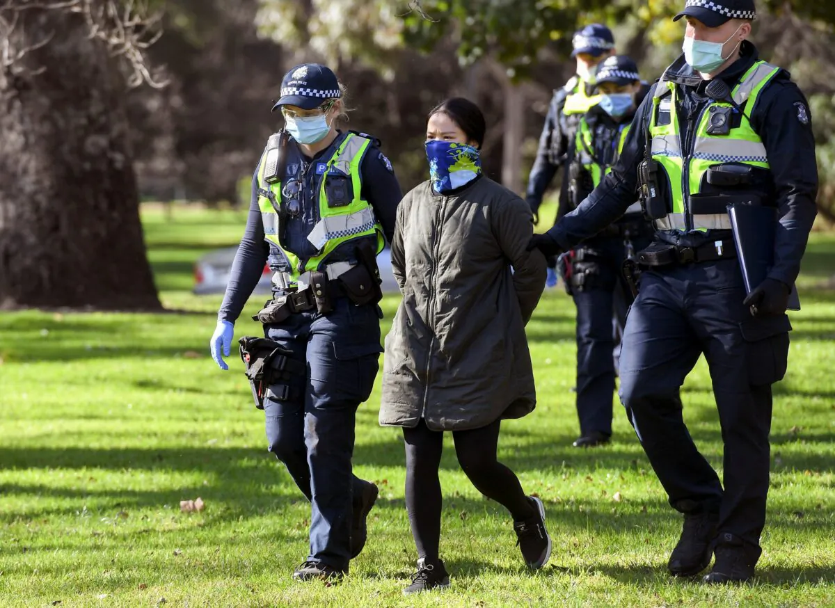Police detain a protester in Melbourne, Australia, on July 31, 2020. (William West/AFP via Getty Images)