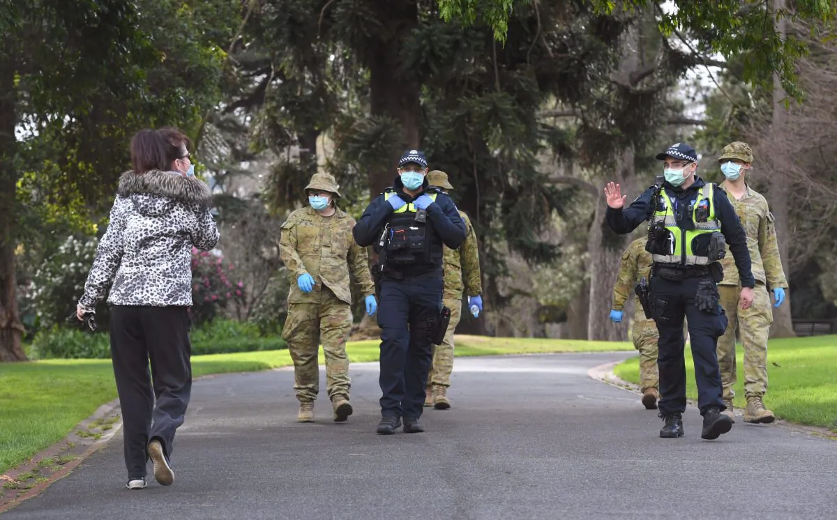 Police officers and soldiers patrol Treasury Gardens as they enforced strict lockdown laws in Melbourne, Australia on Aug. 5, 2020.(William West/ AFP via Getty Images)