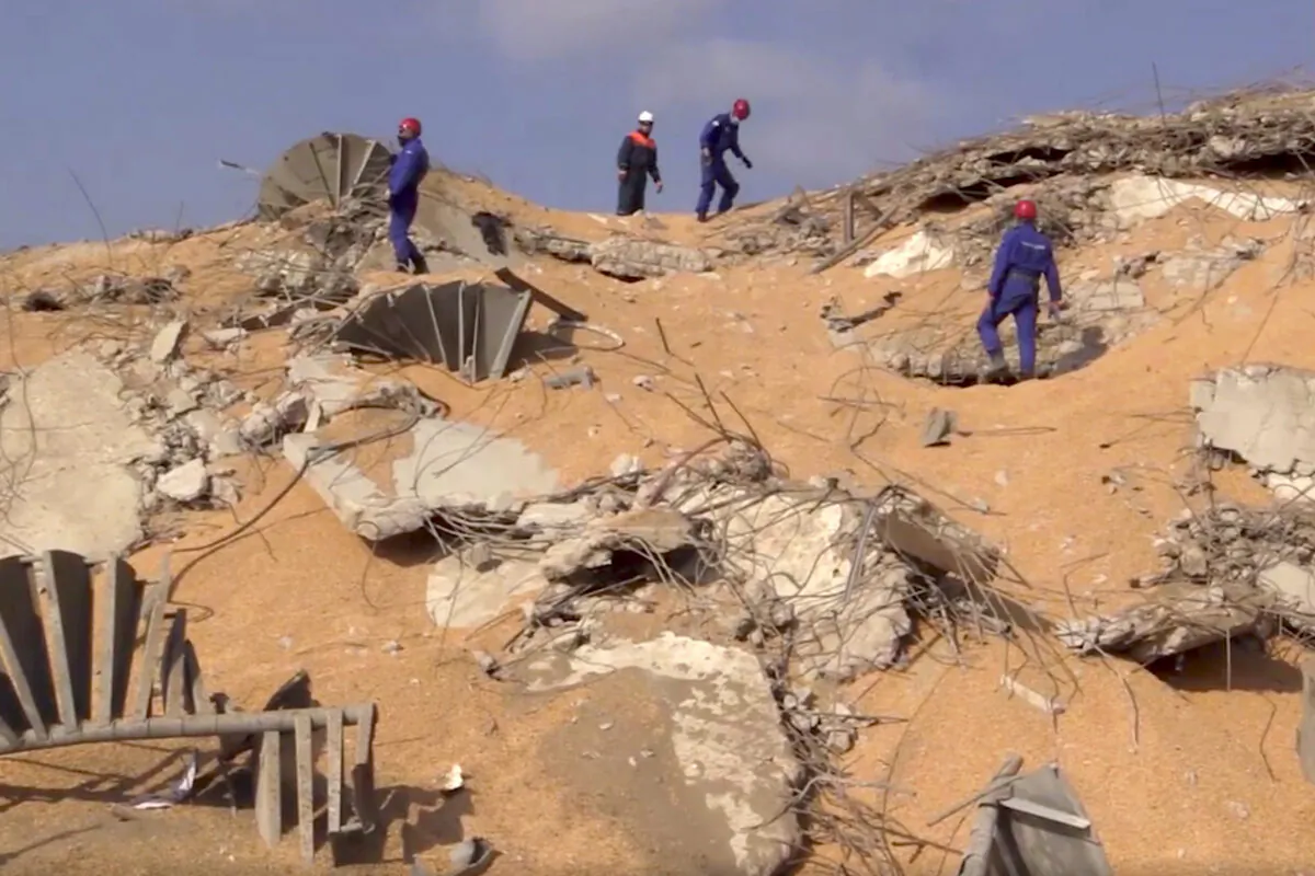 In this photo taken from footage provided by the Russian Emergency Situations Ministry press service, Russian Emergency Situations personnel walk on the site of the explosion in the port of Beirut, Lebanon, on Aug. 6, 2020. (Ministry of Emergency Situations press service via AP/AP Photo)