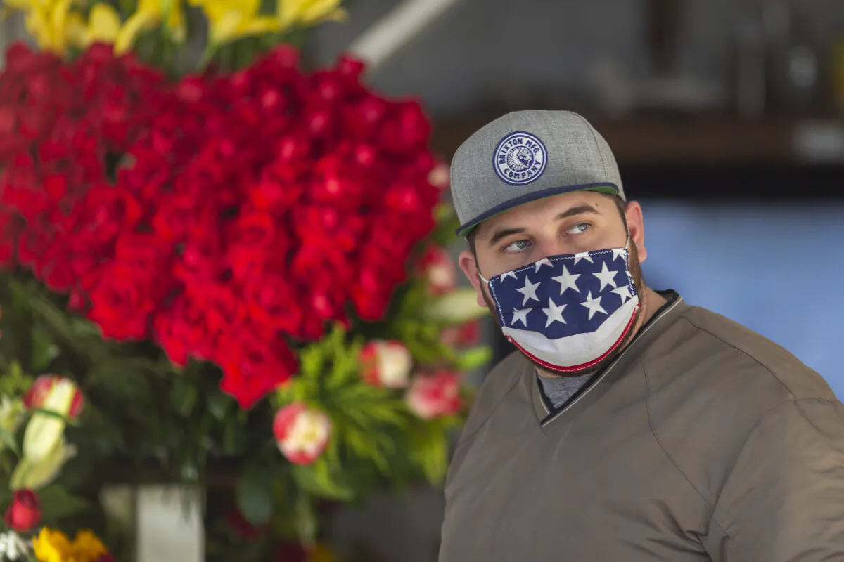 A man wears a patriotic face covering in the Flower District in downtown Los Angeles on May 8, 2020. (David McNew/Getty Images)