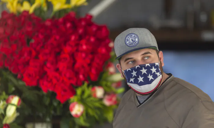 A man wears a patriotic face covering in the Flower District in downtown Los Angeles on May 8, 2020. (David McNew/Getty Images)