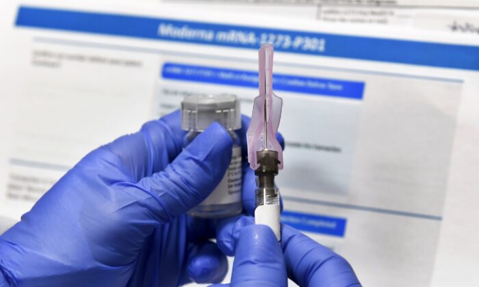 A nurse prepares a shot as a study of a possible COVID-19 vaccine, developed by the National Institutes of Health and Moderna Inc., gets underway in Binghamton, N.Y., on July 27, 2020. (Hans Pennink/AP Photo)